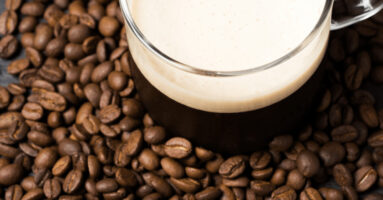 Nitro brew coffee on pile of coffee beans