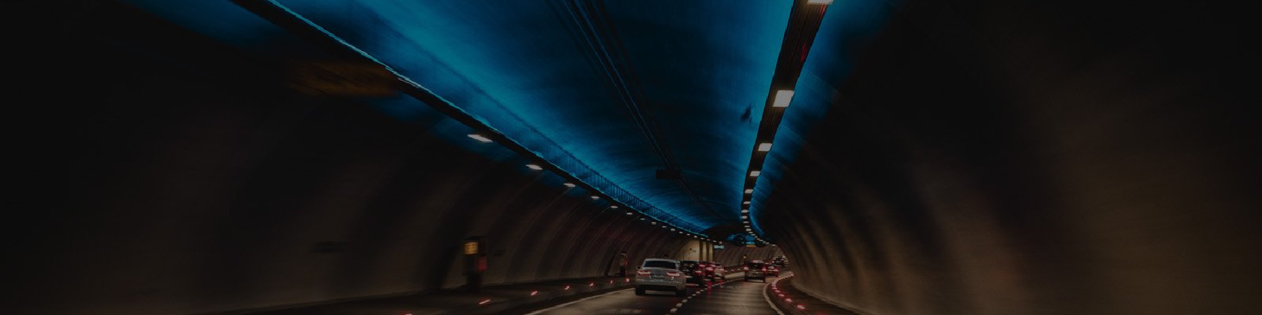 Image of cars driving through tunnel at night