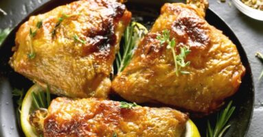 Baked chicken on plate with thyme and slices of lemon - Middleby Marshall WOW! conveyor oven