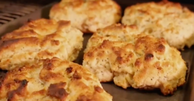 close up of biscuits exiting a conveyor oven