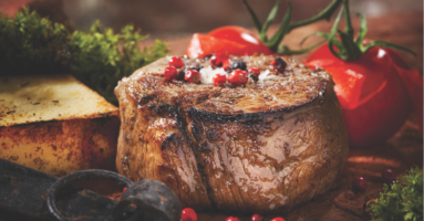 close up of a cooked filet with cherry tomatoes